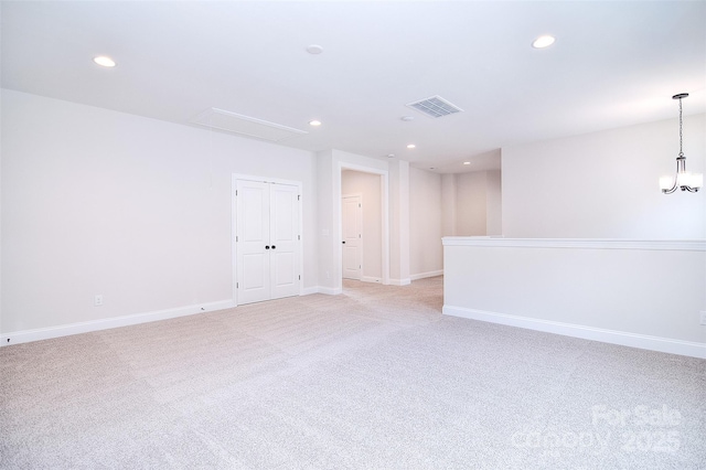 empty room with baseboards, recessed lighting, visible vents, and attic access