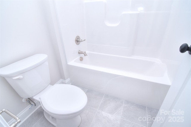 full bathroom featuring tile patterned flooring, toilet, and shower / bathtub combination