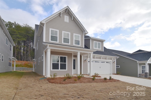 traditional-style home featuring a front lawn, concrete driveway, a porch, and an attached garage