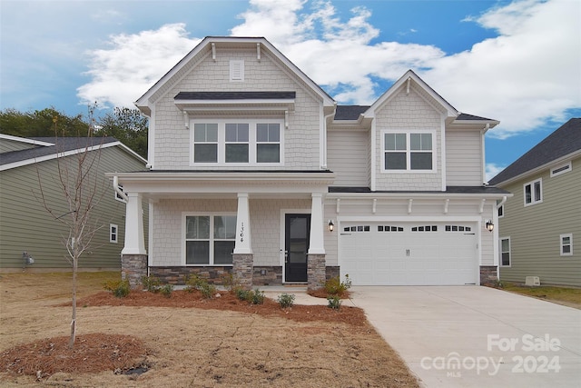 craftsman-style home with covered porch and a garage