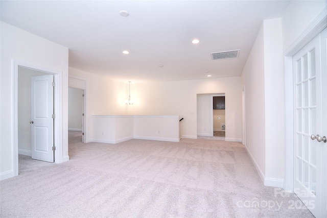 empty room with baseboards, recessed lighting, visible vents, and light colored carpet