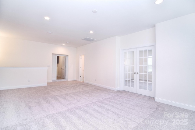 unfurnished room featuring recessed lighting, light carpet, visible vents, baseboards, and french doors