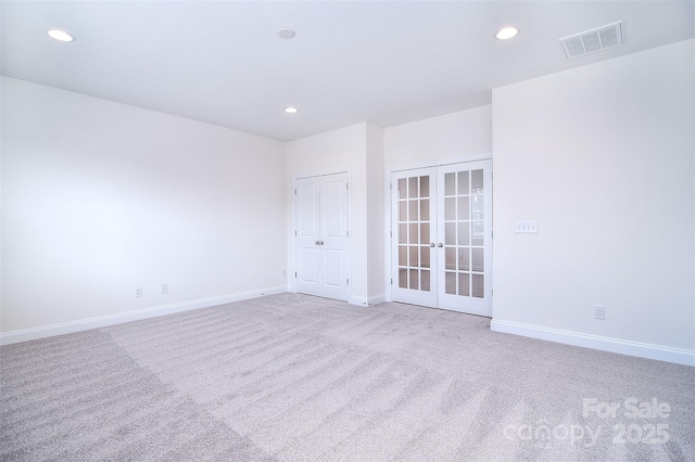 unfurnished room featuring carpet floors, french doors, recessed lighting, visible vents, and baseboards