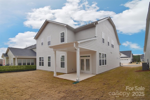 back of house with a patio area, a yard, central AC unit, and french doors