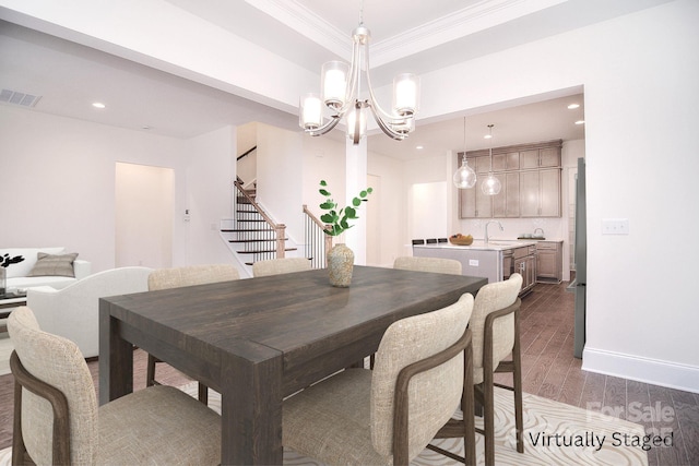 dining space featuring dark wood-style flooring, crown molding, visible vents, a chandelier, and stairs