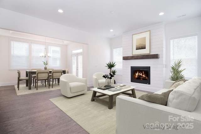 living room with recessed lighting, a fireplace, wood finished floors, visible vents, and baseboards