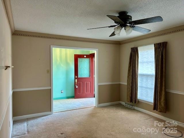 unfurnished room featuring light carpet, ceiling fan, and a textured ceiling