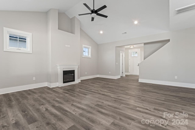 unfurnished living room with ceiling fan, dark hardwood / wood-style flooring, and high vaulted ceiling