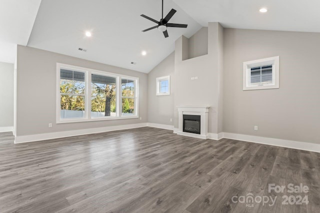 unfurnished living room with hardwood / wood-style flooring, high vaulted ceiling, and ceiling fan