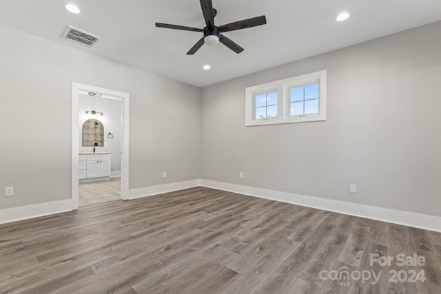 unfurnished room with ceiling fan and wood-type flooring