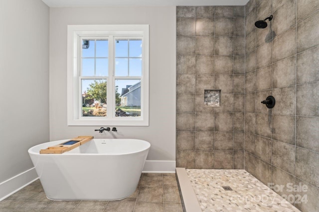 bathroom featuring tile patterned flooring and separate shower and tub