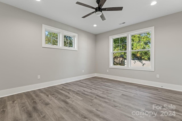 empty room featuring ceiling fan and light hardwood / wood-style floors