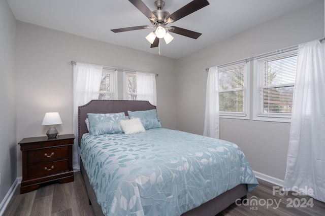 bedroom featuring ceiling fan and dark wood-type flooring