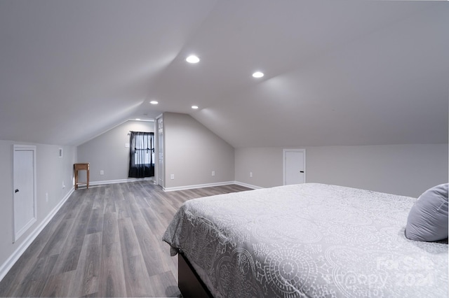 bedroom featuring wood-type flooring and vaulted ceiling