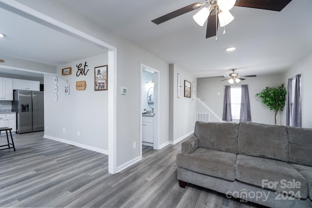 living room with ceiling fan and hardwood / wood-style floors