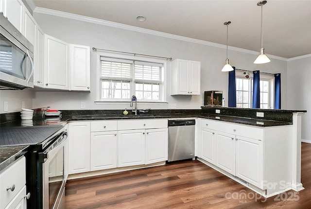 kitchen featuring kitchen peninsula, hanging light fixtures, white cabinetry, appliances with stainless steel finishes, and sink