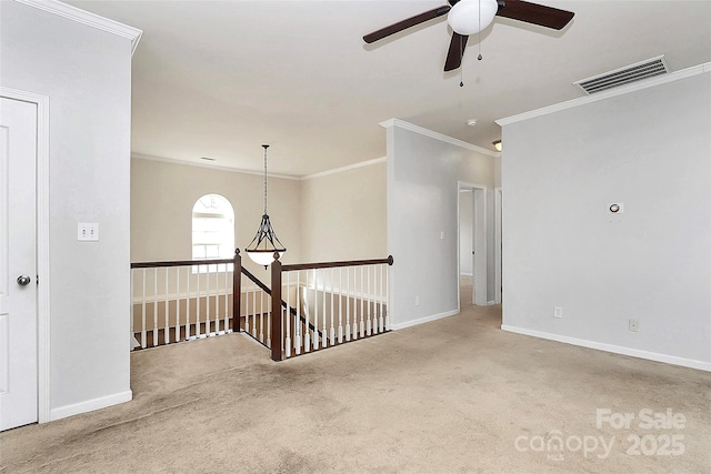 carpeted empty room with ornamental molding and ceiling fan