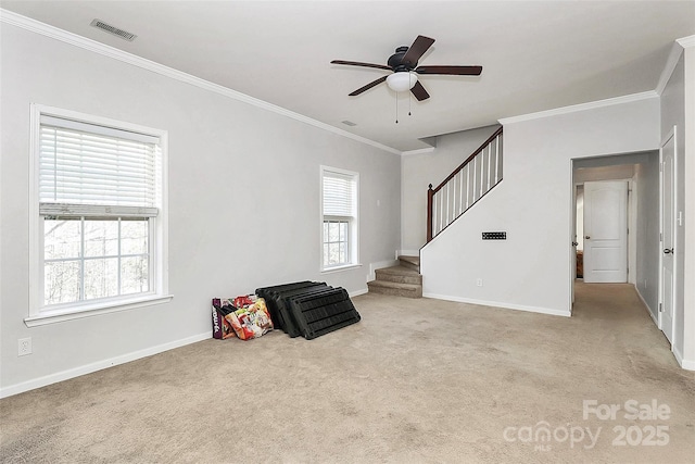 living room featuring ceiling fan, ornamental molding, and light carpet