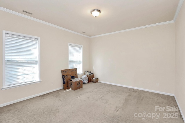 empty room with crown molding and light colored carpet