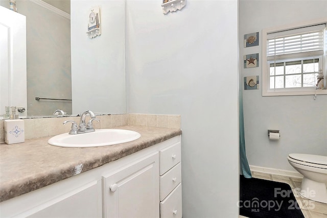 bathroom with vanity, crown molding, tile patterned floors, and toilet