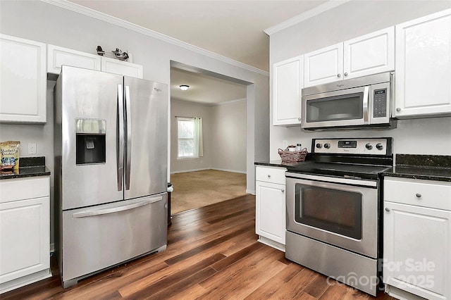 kitchen with stainless steel appliances, crown molding, dark hardwood / wood-style floors, and white cabinets