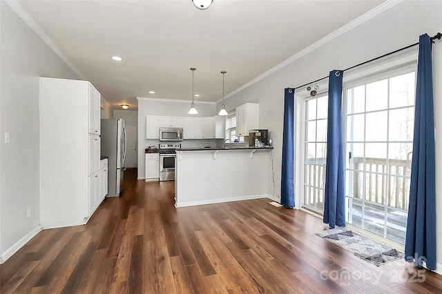 kitchen featuring pendant lighting, dark wood-type flooring, stainless steel appliances, white cabinets, and kitchen peninsula