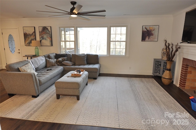 living room with hardwood / wood-style flooring, a brick fireplace, and ornamental molding