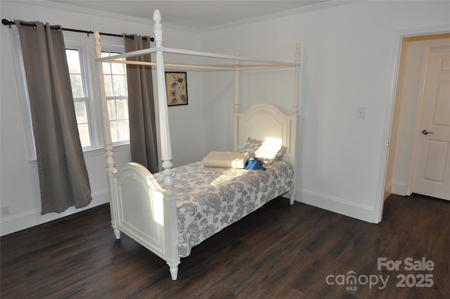 bedroom with dark hardwood / wood-style flooring and crown molding