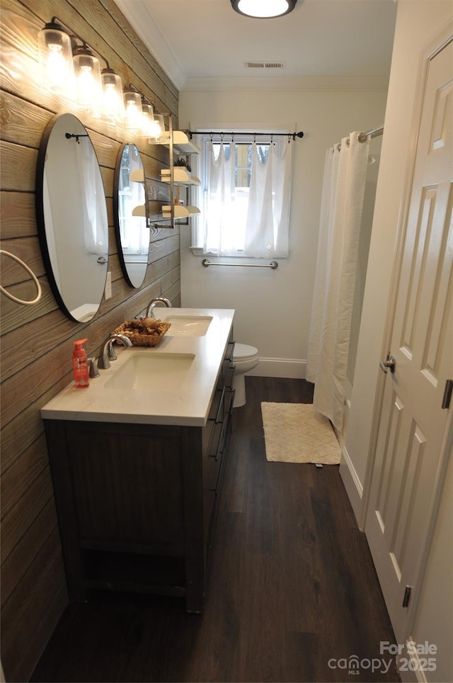 bathroom with curtained shower, crown molding, hardwood / wood-style floors, toilet, and vanity