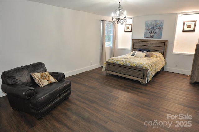 bedroom with a chandelier and dark hardwood / wood-style floors