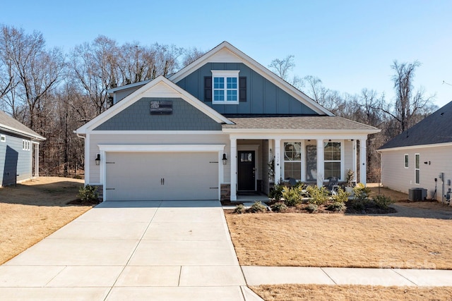 view of front of house with a front yard, a garage, and covered porch