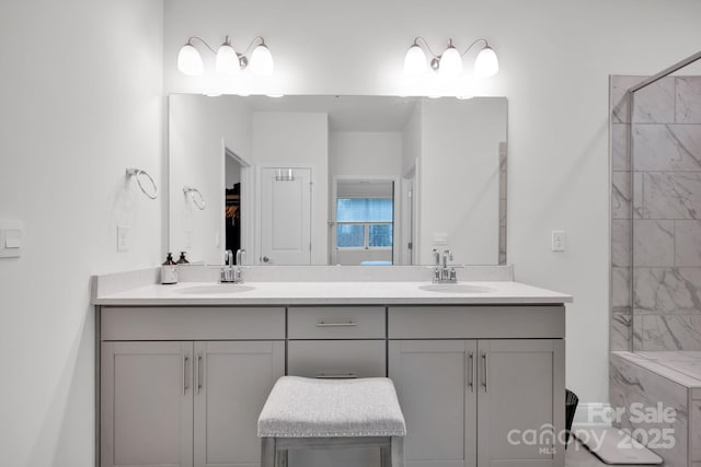 bathroom featuring vanity and tiled shower