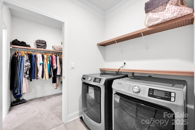 laundry room with light carpet, separate washer and dryer, and crown molding