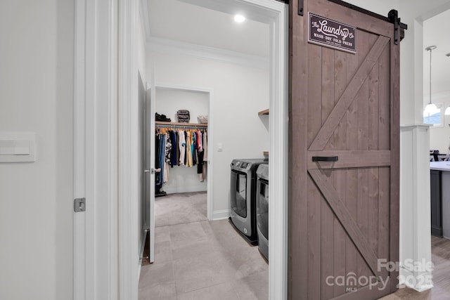 spacious closet with a barn door and separate washer and dryer