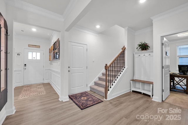 entryway featuring light hardwood / wood-style flooring and ornamental molding