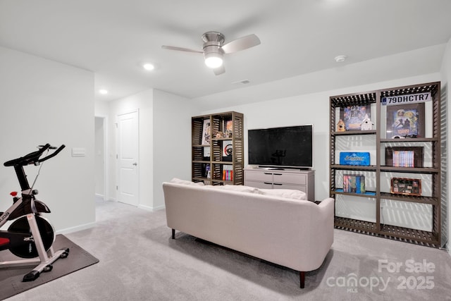 carpeted living room with ceiling fan