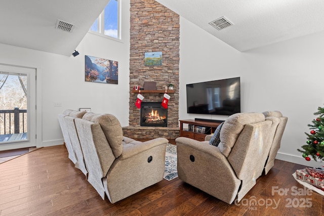 living room with high vaulted ceiling, a fireplace, and dark hardwood / wood-style flooring