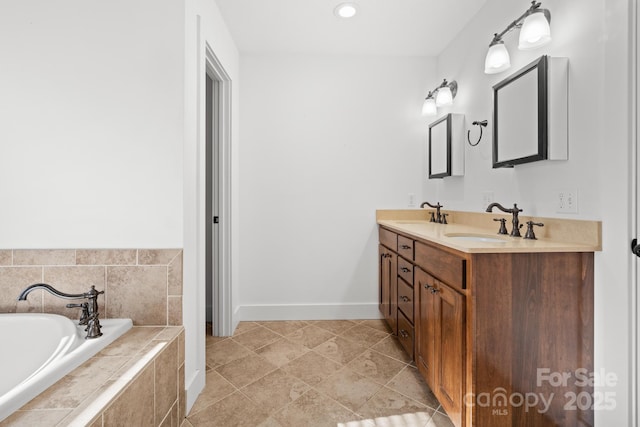 bathroom with vanity and tiled tub