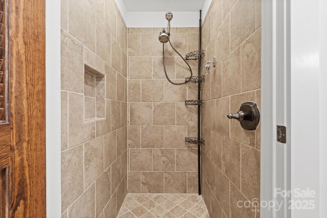 bathroom with a tile shower