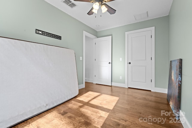 unfurnished bedroom featuring hardwood / wood-style flooring and ceiling fan