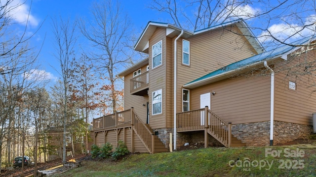 back of house featuring a deck