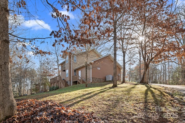 view of side of home with a lawn