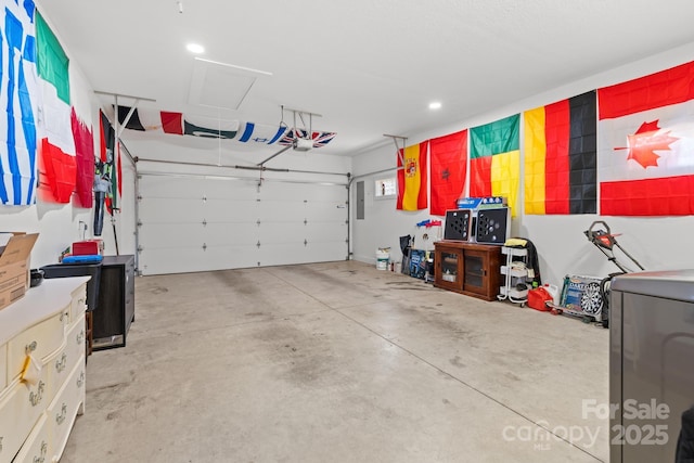 garage with a garage door opener, electric panel, and washer / clothes dryer