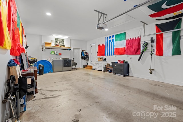 garage with washing machine and clothes dryer and a garage door opener