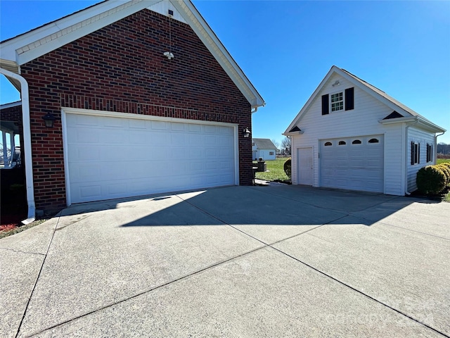 view of side of property featuring an outbuilding and a garage