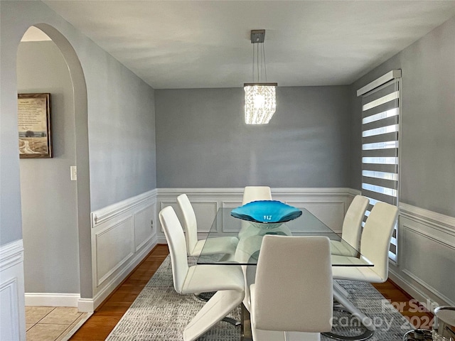 dining room featuring an inviting chandelier and hardwood / wood-style flooring