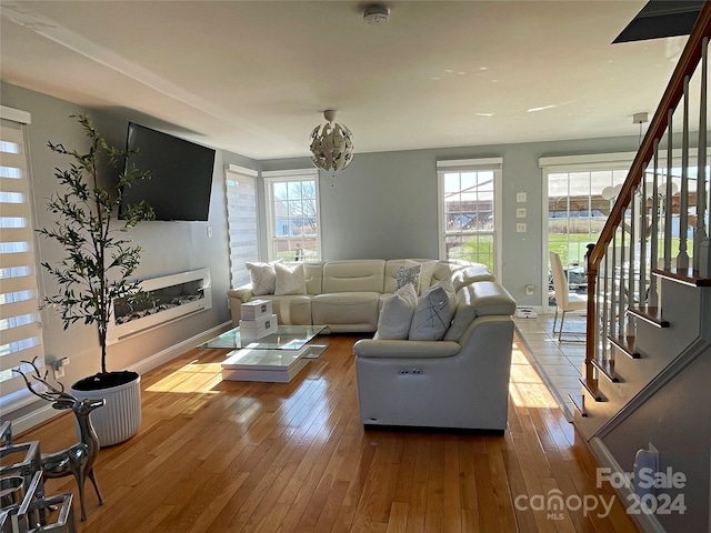 living room with hardwood / wood-style floors and a notable chandelier