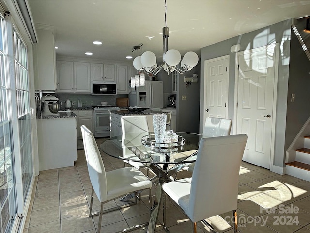 dining room featuring light tile patterned floors and an inviting chandelier