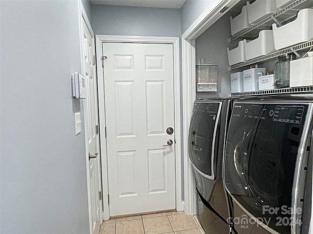 laundry room featuring separate washer and dryer and light tile patterned floors