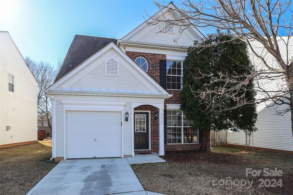 greek revival house featuring a garage